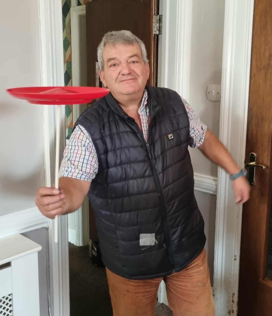 man juggling a plate happily