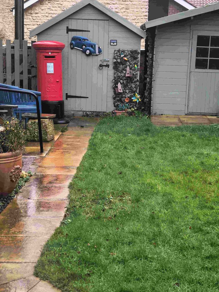 Garden with sheds and postbox
